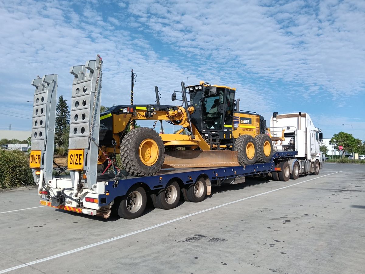 Drop deck widener with grader